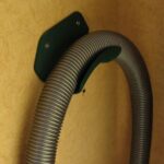 vacuum cleaner hose mounting bracket